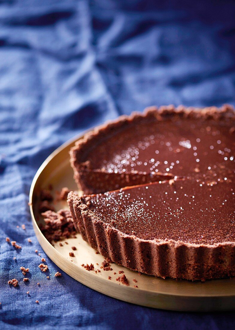 Dark chocolate tart, with a small slice removed
