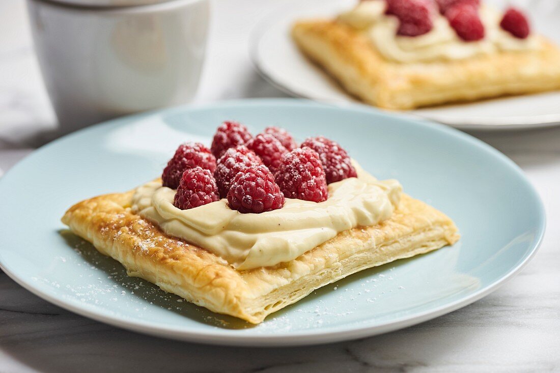 Puff pastry slices with vanilla cream and raspberries