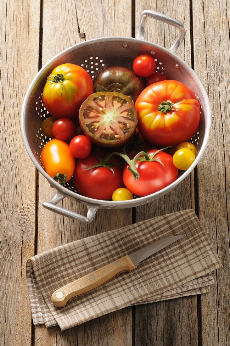 Various types of tomatoes in a colander
