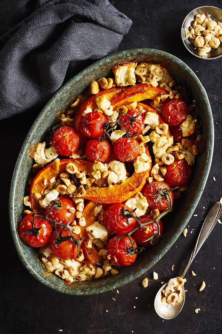 Roasted pumpkin with cherry tomatoes, sheep's cheese, and hazelnuts