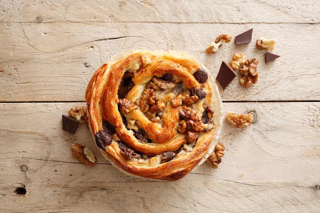 A puff pastry snail with chocolate and walnuts