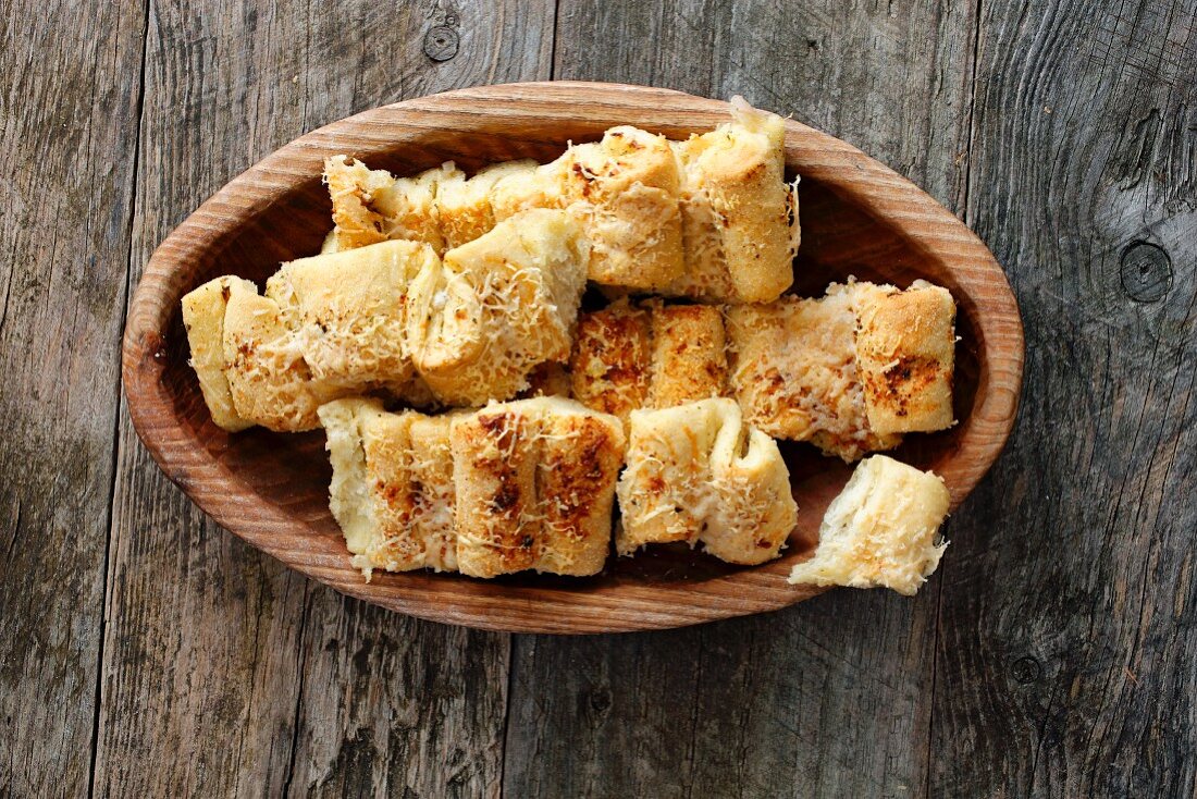 Pizza pull apart bread in a wooden bowl