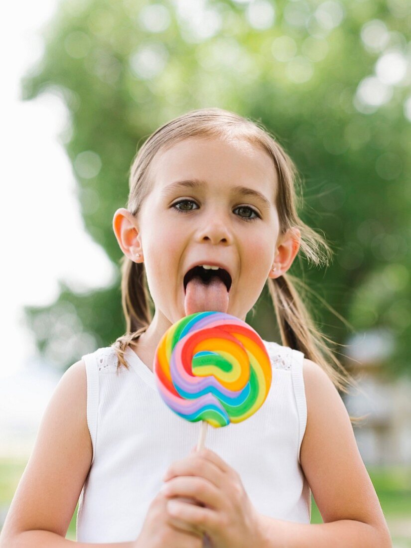 Girl licking colorful lollipop