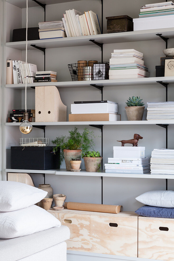 Stacked magazines and ornaments arranged on shelves