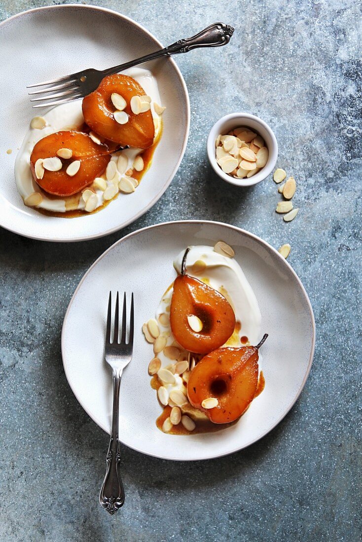 Roasted pears in caramel sauce served with yogurt and almonds