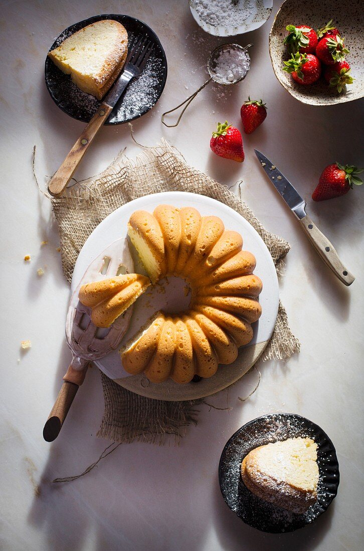 Cream cheese bundt cake on a ceramic plate on a marble table