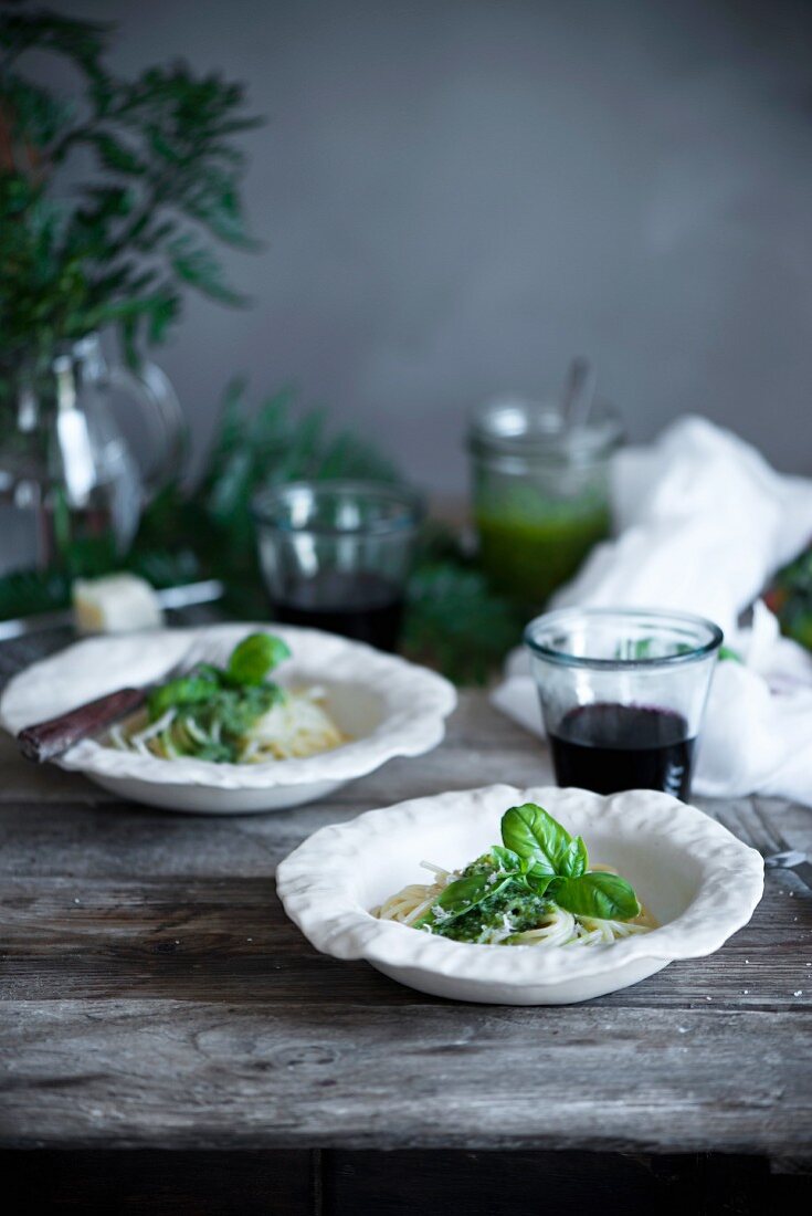 Spaghetti with pesto and decorated with basil leaves