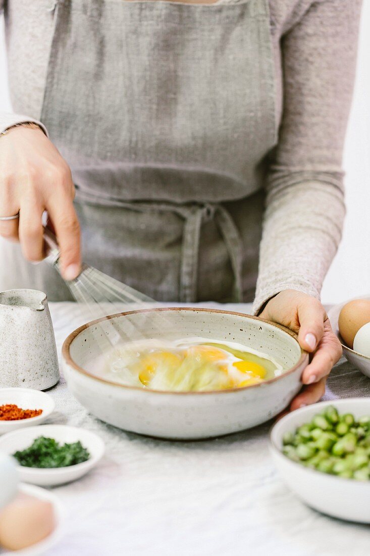 A woman preparing breakfast eggs