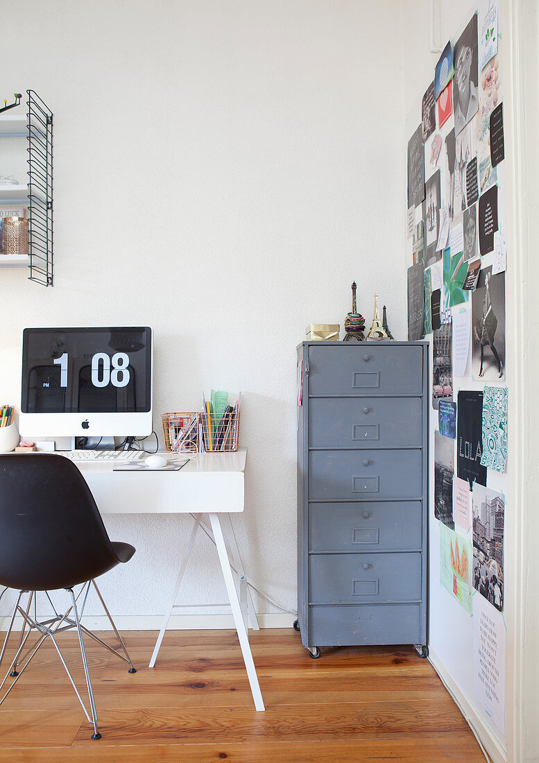 Time displayed on computer monitor on desk next to collage