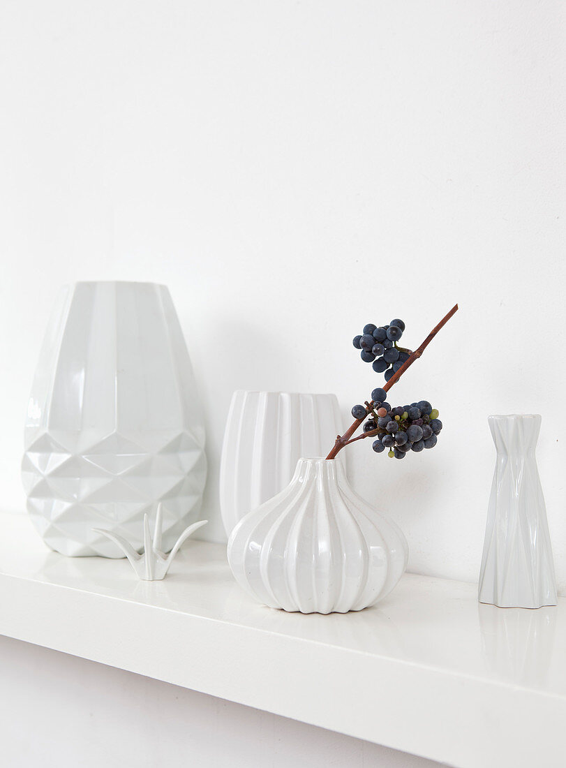White structured vases on shelf
