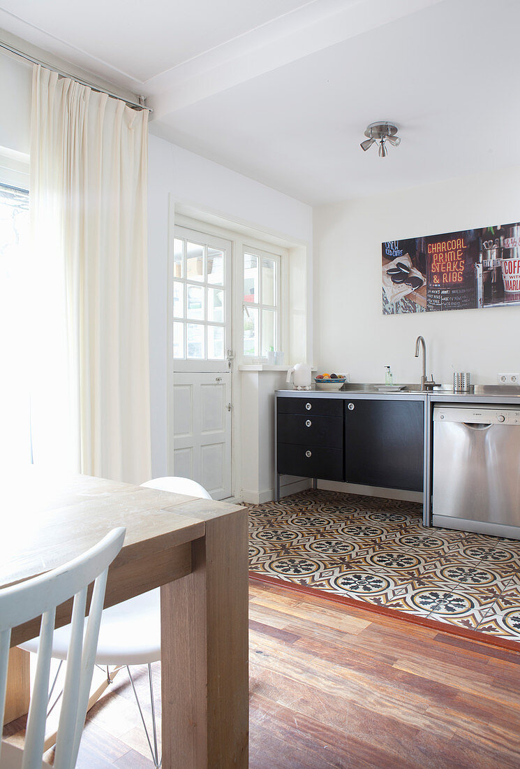 Various floor coverings in open-plan dining room and kitchen