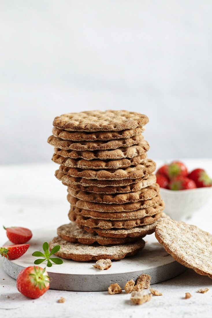 A stack of crackers and fresh strawberries