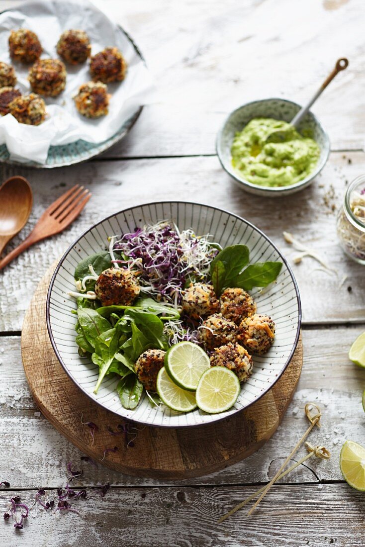 Quinoa and carrot balls with a lime and avocado dip and sprout salad