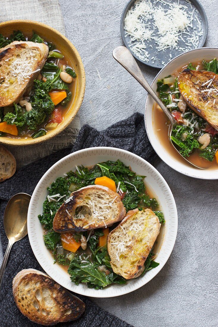 Ribollita soup with kale, carrot, tomatoes, parmesan and bread