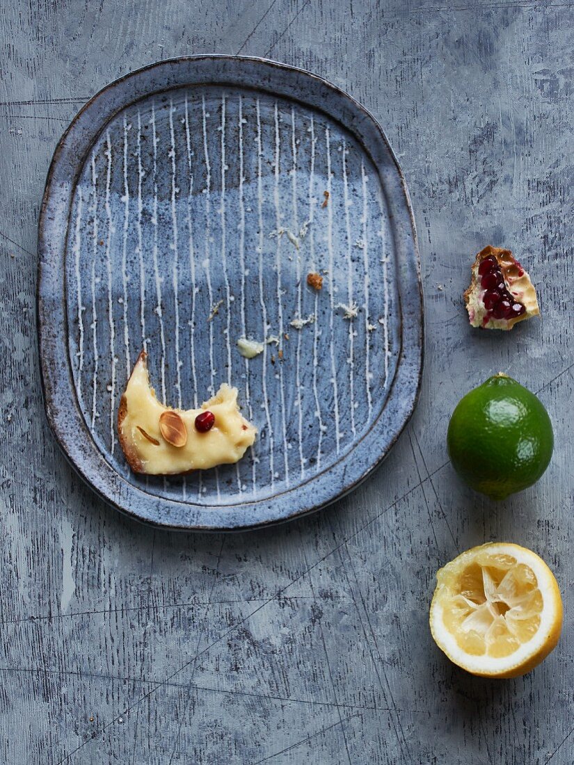 Leftover toast bread with lemon curd, caramelised lime peel, almonds and pomegranate seeds