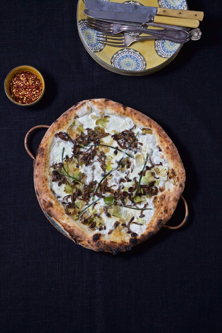Pizza bianca with mushrooms, leek and chives (seen from above)
