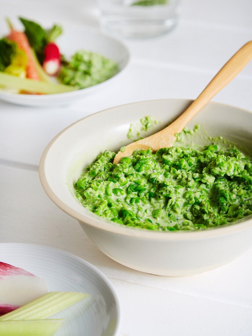 A pea dip served with baby crudité veg (carrots, breakfast radish, radicchio, lettuce)