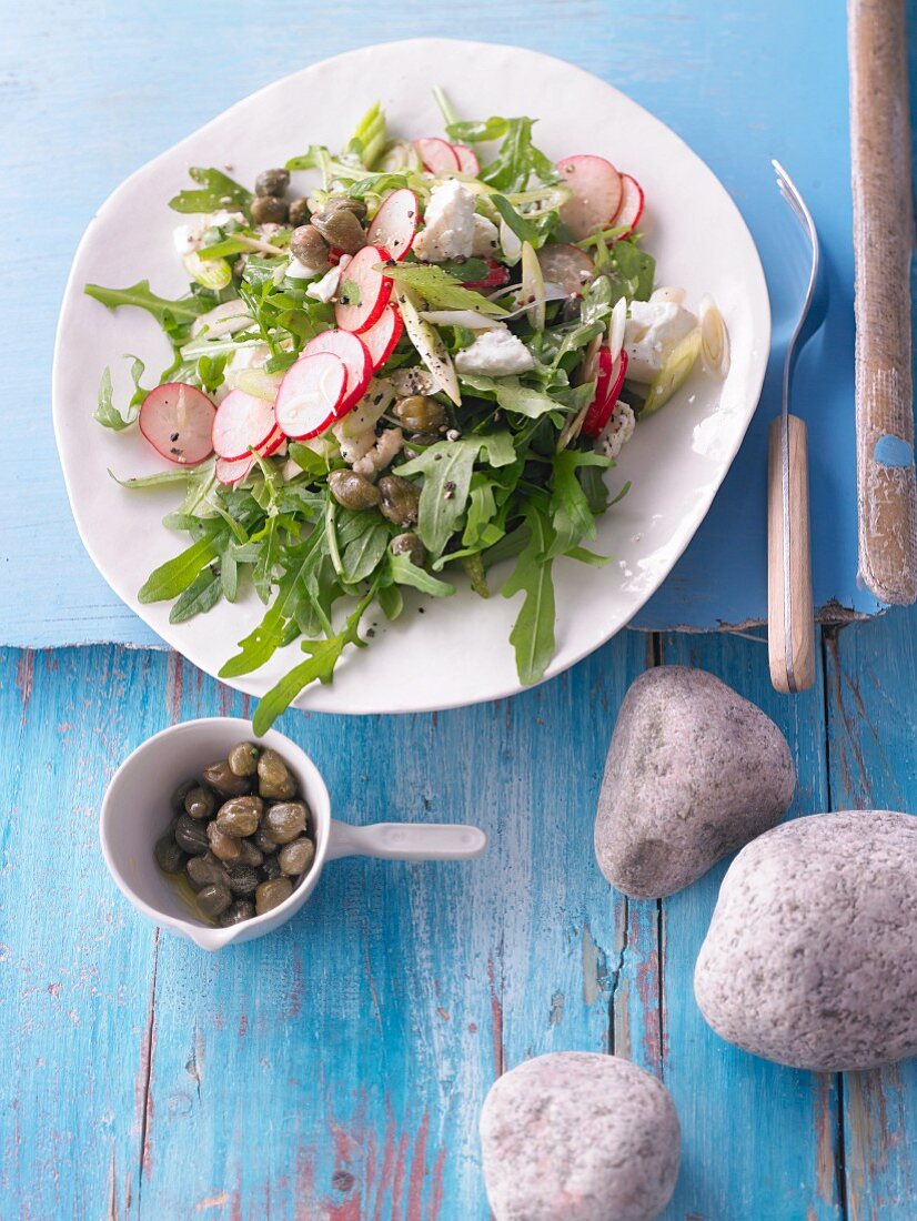 Rocket salad with radishes, feta, and capers