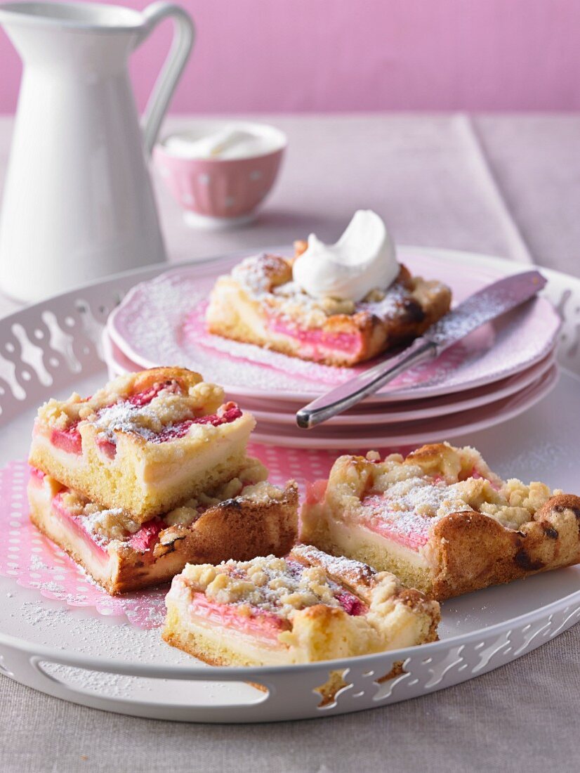 Rhubarb cake with icing sugar and cream