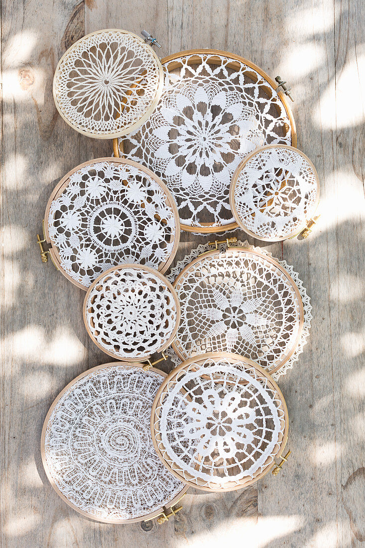 Lace doilies mounted in embroidery frames