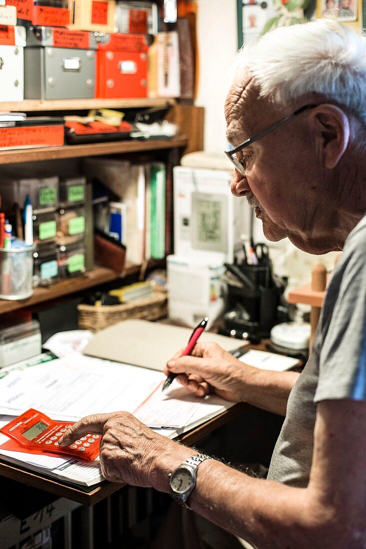 Elderly man calculating finances