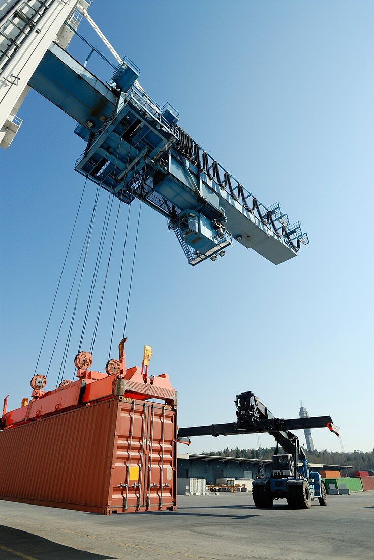 Crane lowering shipping container