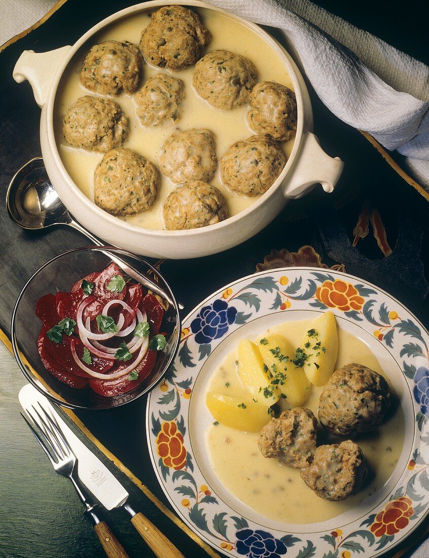 Königsberger meatballs with potatoes on plate & in terrine