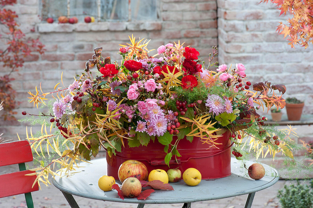 Autumn arrangement in red tin pot