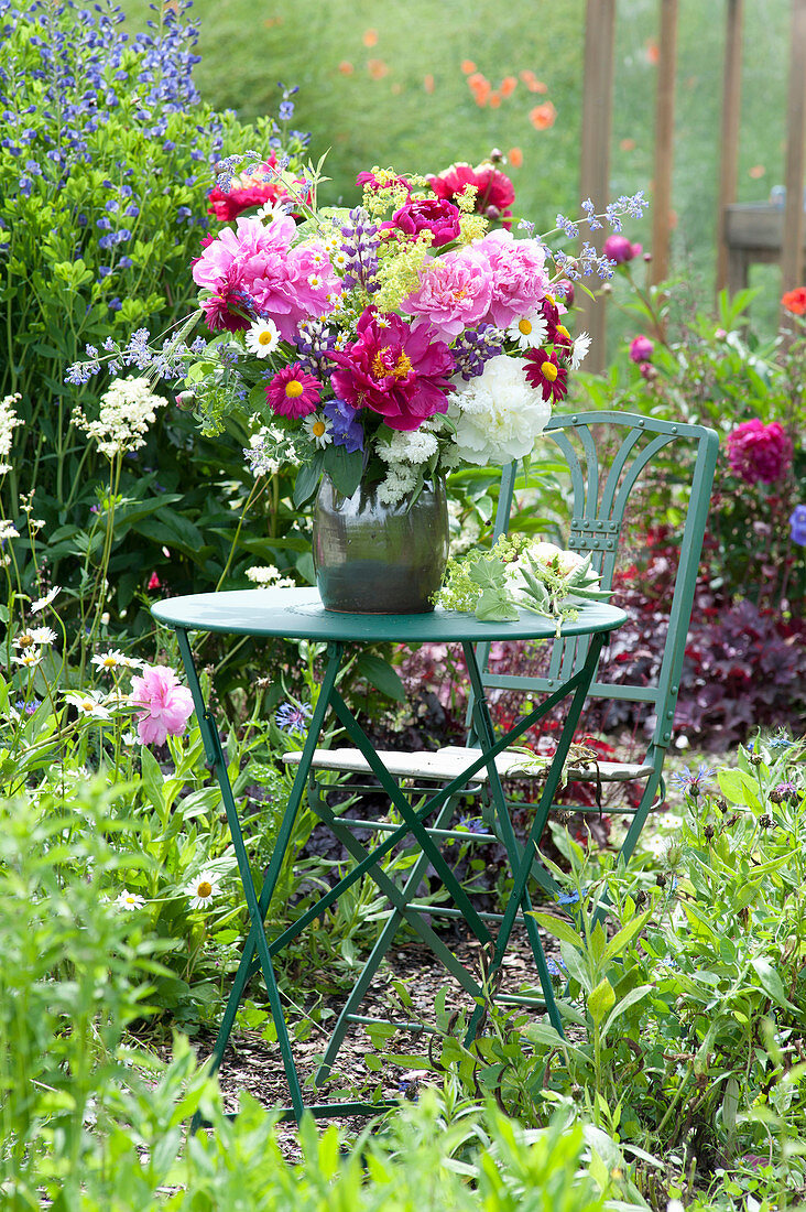 Early summer bouquet on table in the garden