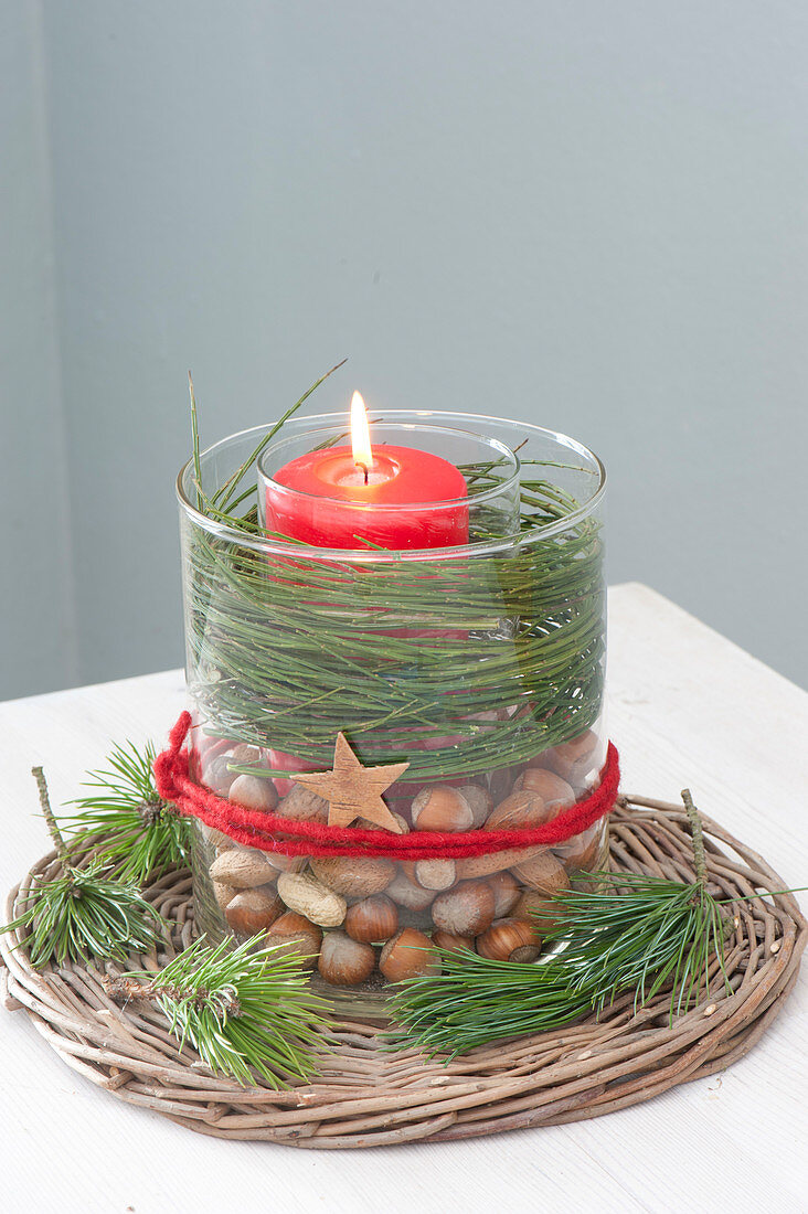 Glass in glass candle decoration, glass with red candle in big glass