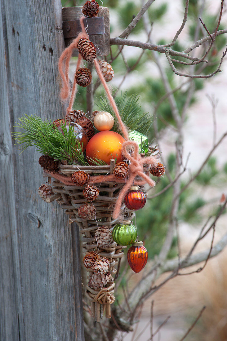 Self made wicker basket decorated with Christmas tree baubles