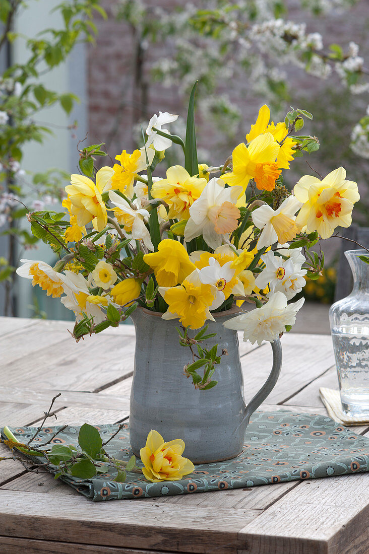 Bouquet of mixed Narcissus and branches of Carpinus