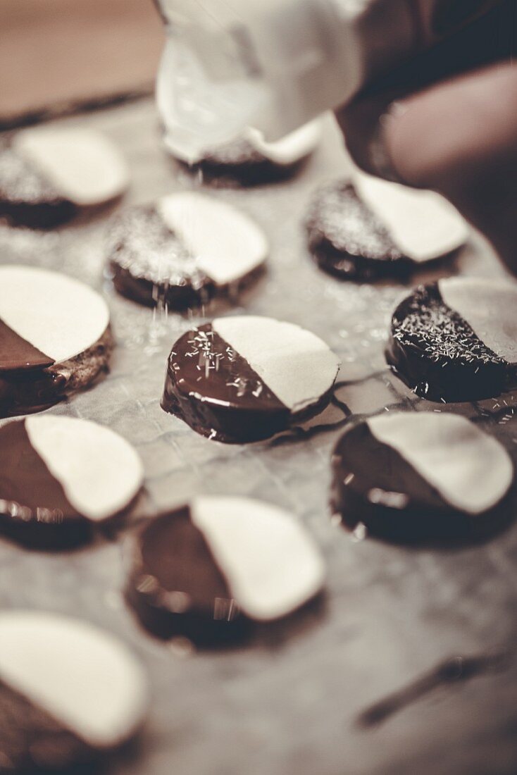 Round date biscuits topped with chocolate and desiccated coconut