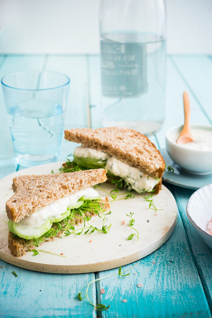 Wholemeal sandwich with pea shoots, cucumber and herb cream cheese