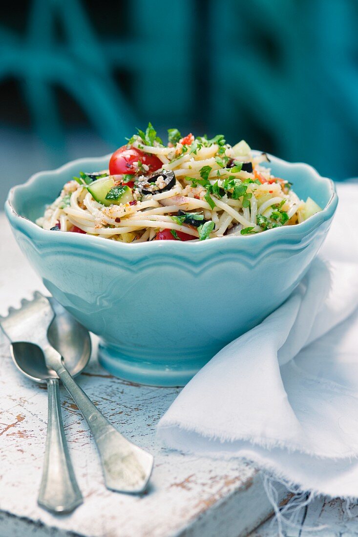 Noodle salad with cherry tomatoes, olives and cucumbers
