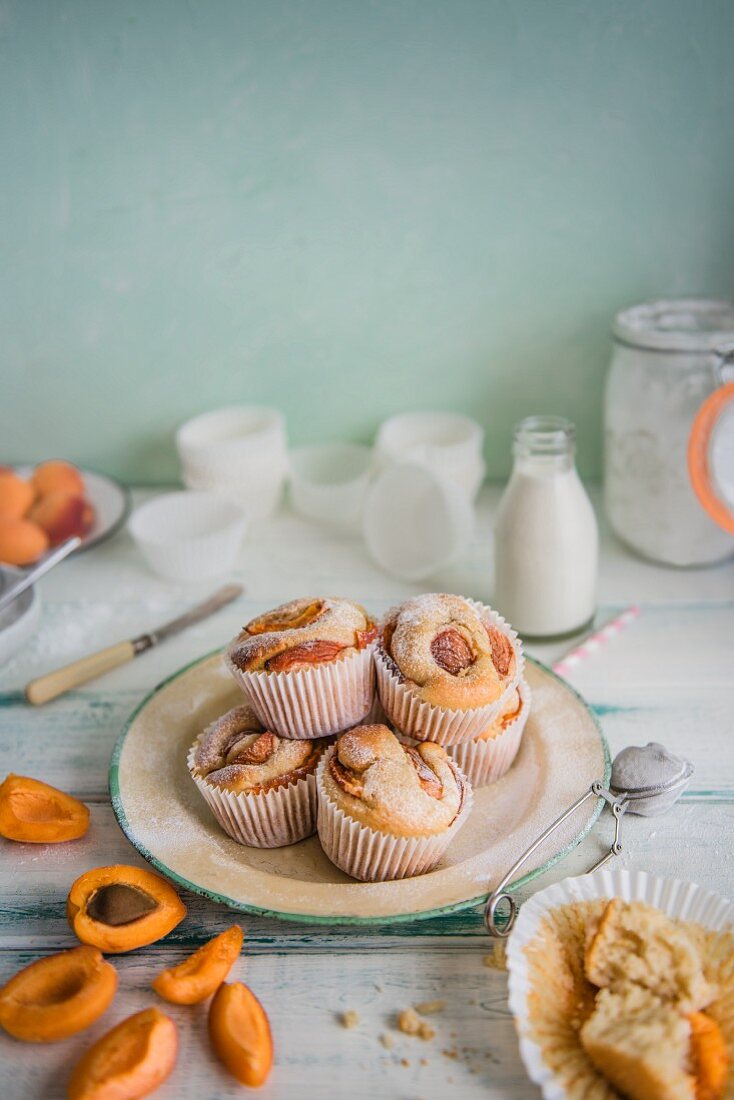 Apricot cupcakes on a plate with icing sugar