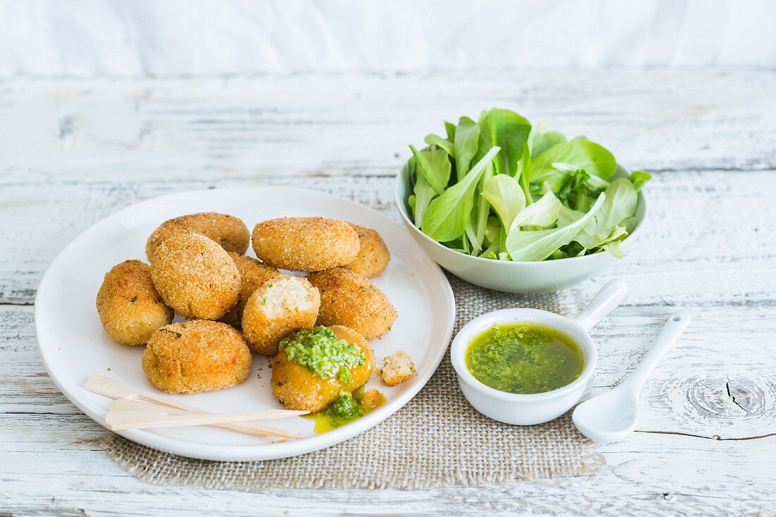 Breaded fishcakes with green sauce