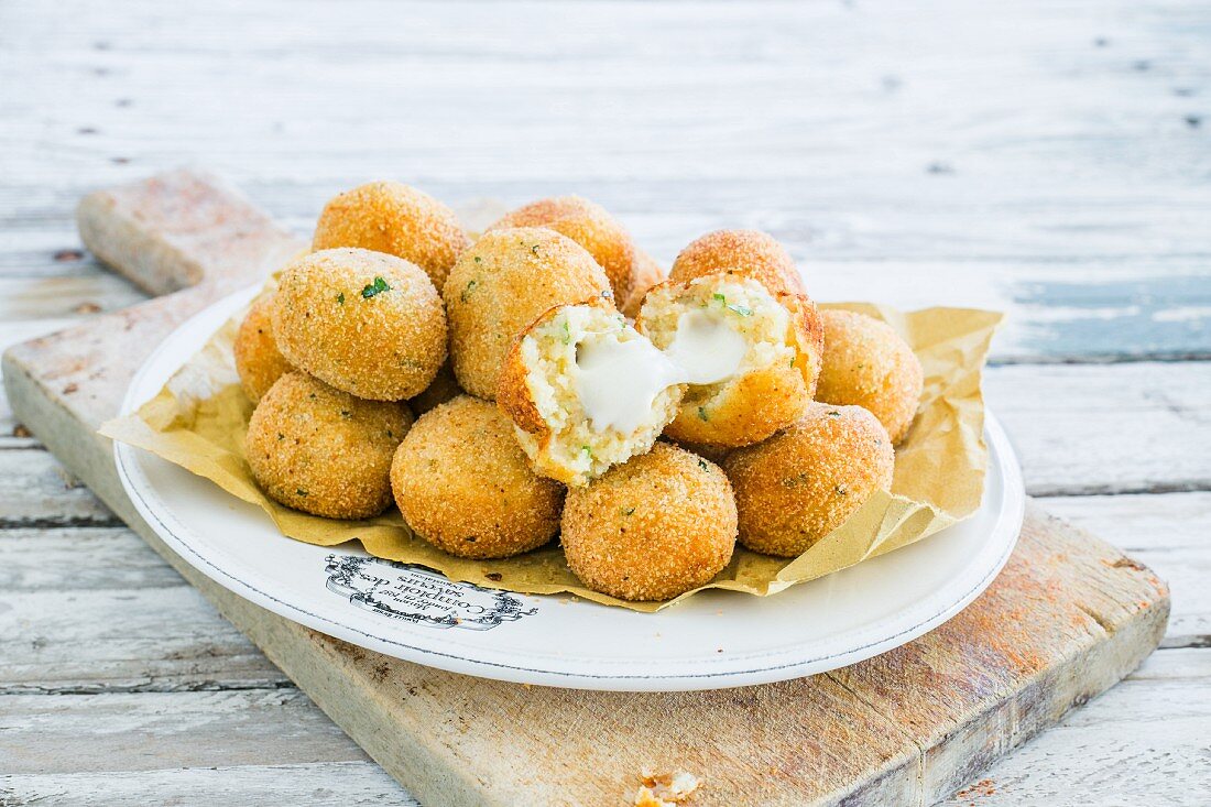 Fried potato balls with cheese centres