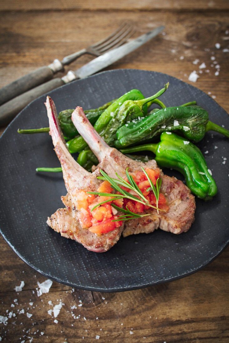 Lamb chops with peppers and tomato cubes