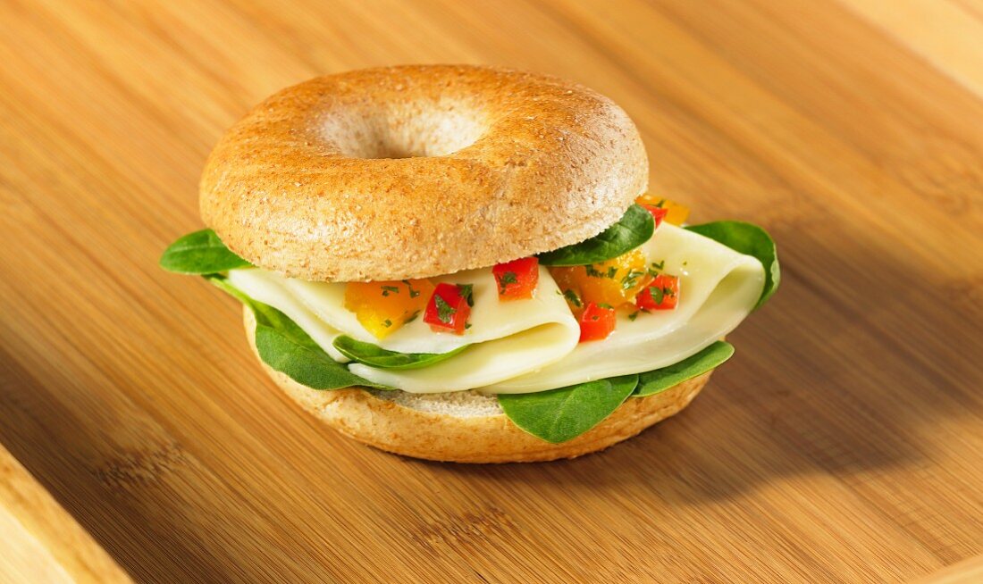 Bagel with cheese, spinach and chopped tomato