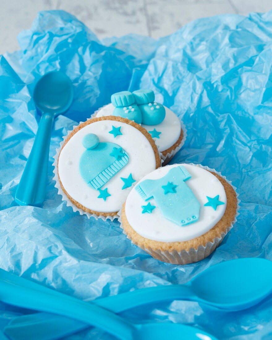 Cupcakes for a baby shower on blue paper
