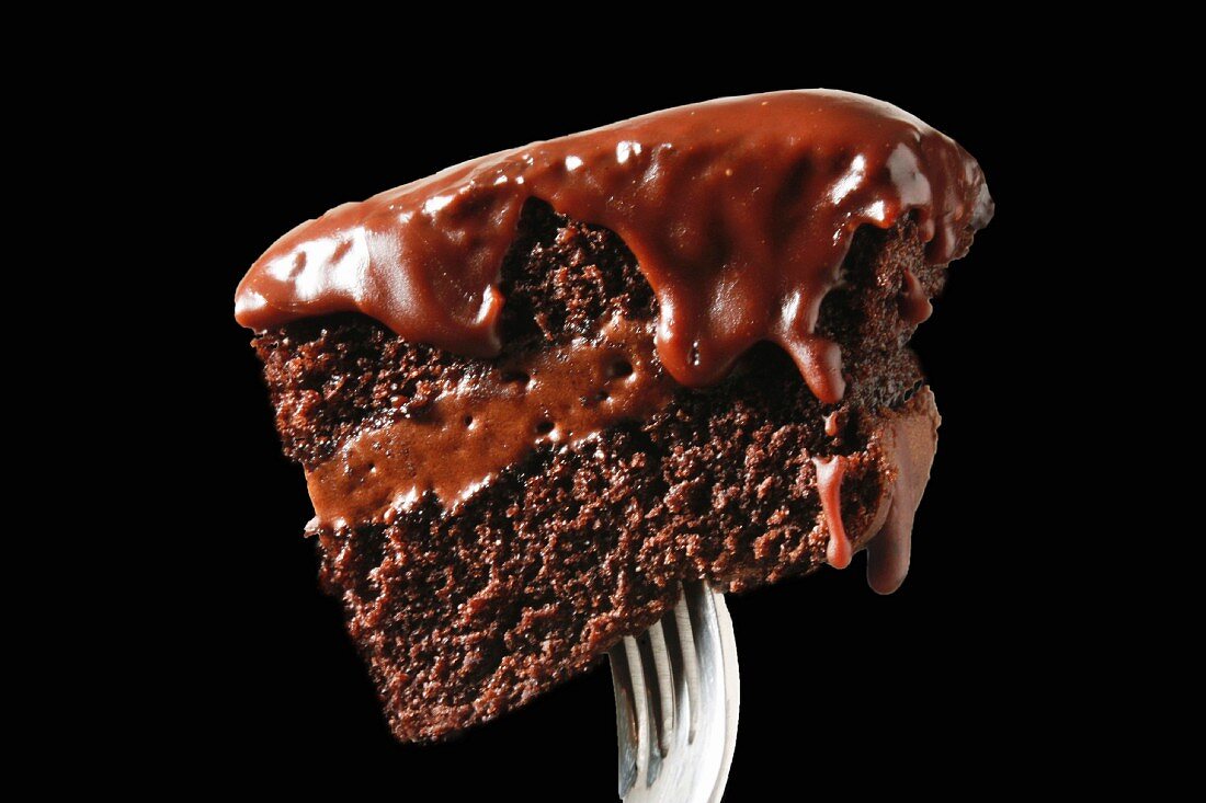 A piece of chocolate cake on a fork