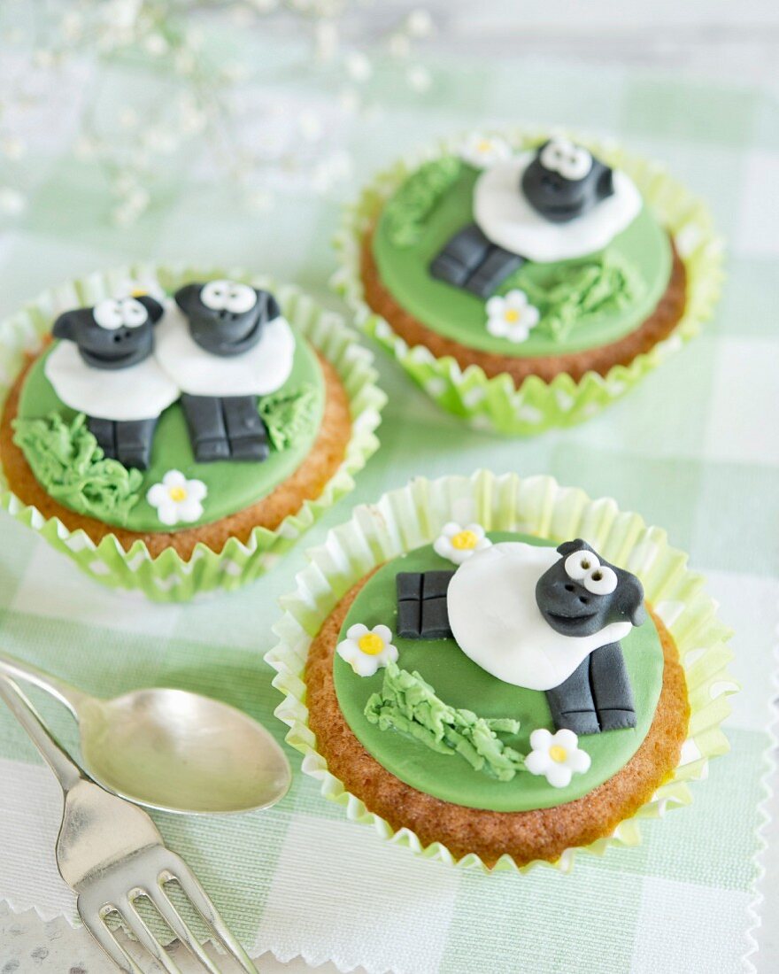 Comical cupcakes decorated with fondant sheep