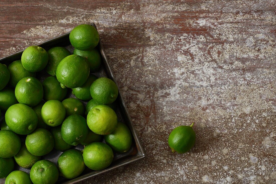A metal tray full of limes