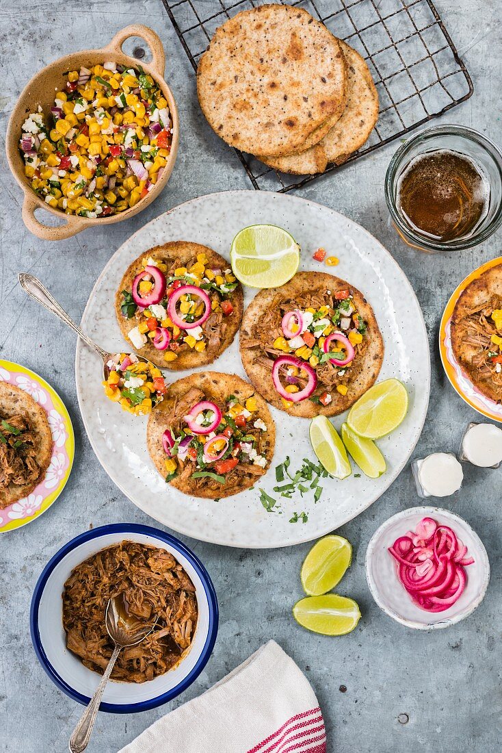 Tostadas with pulled pork, corn salsa and onions