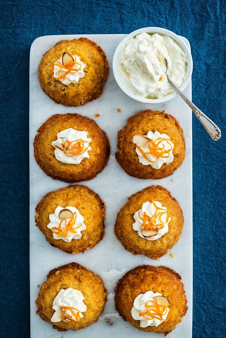 Orange and almond cupcakes with cream (top view)