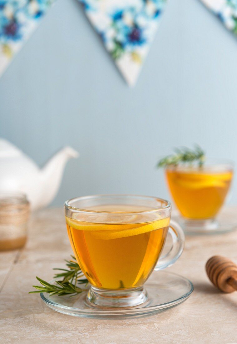 Lemon and rosemary tea in teacups