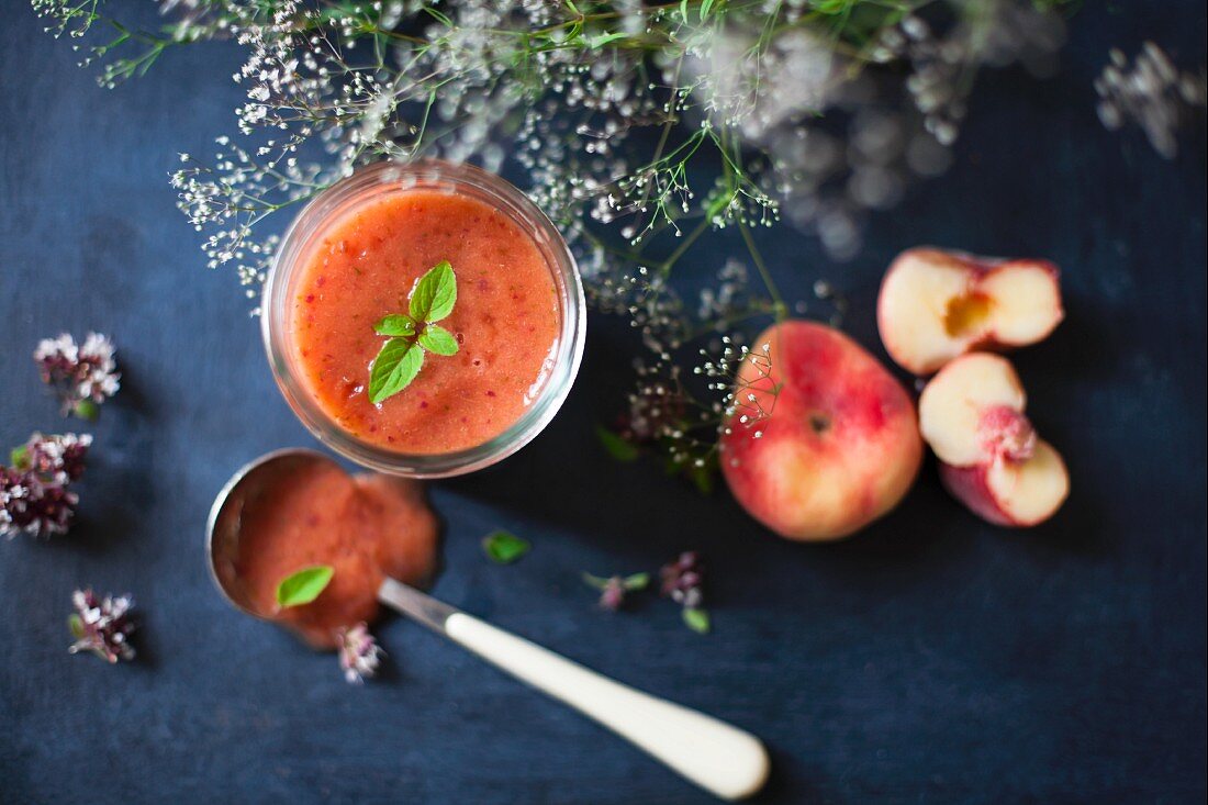 A watermelon and peach smoothie in a glass