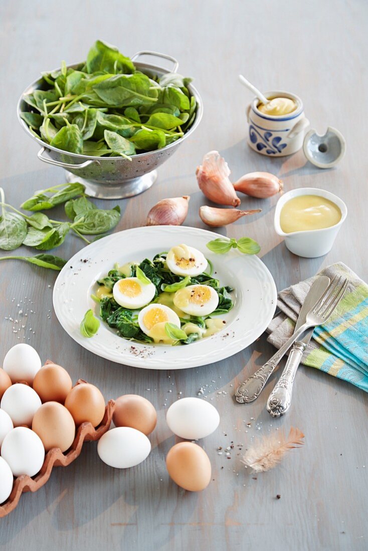 Eggs with mustard sauce and baby leaf spinach