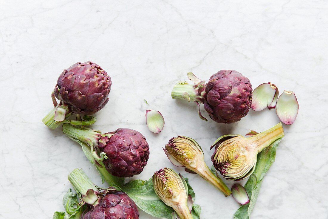 Purple artichokes, sliced and whole